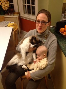 Weighing the difference: the cat is bigger than the 5-month-old baby.